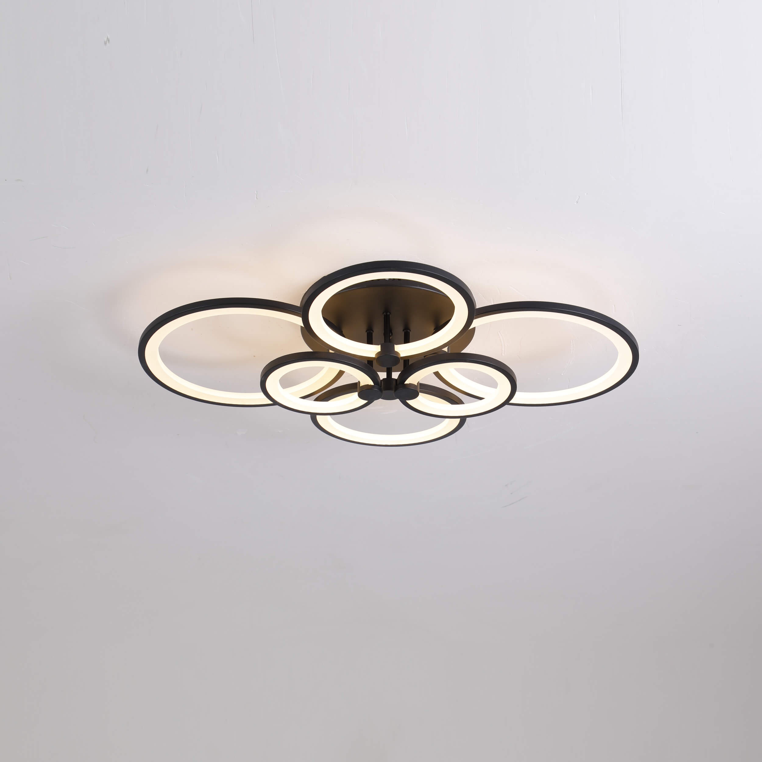 ceiling light features sleek and modern design with a unique circular arrangement of illuminated rings