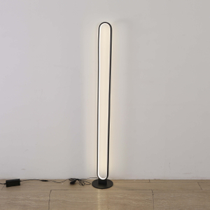 Sleek and modern black floor lamp with an elongated curved design, providing warm ambient lighting.