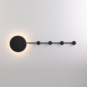 Abstract wall-mounted light fixture with geometric shapes and brass accents