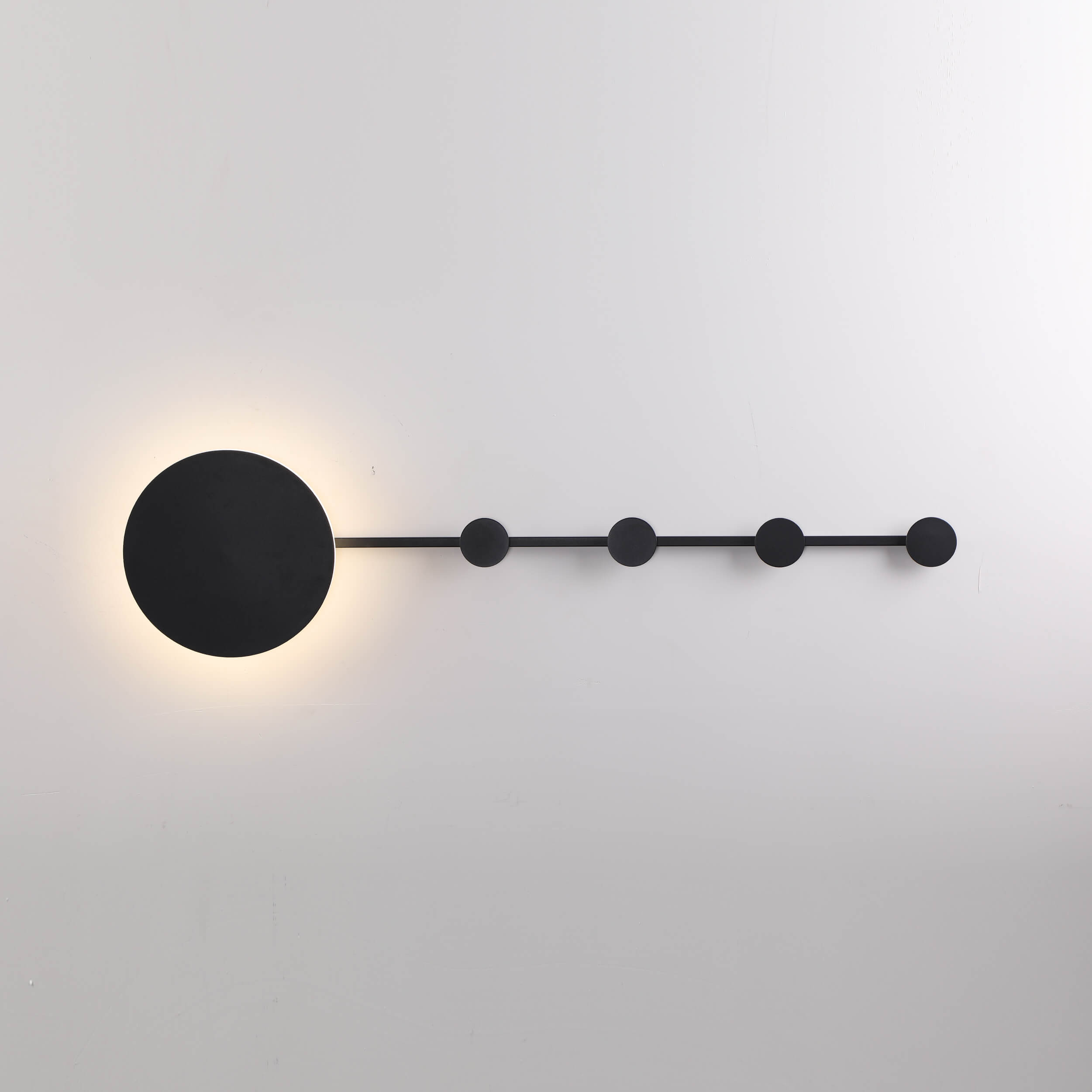 Abstract wall-mounted light fixture with geometric shapes and brass accents
