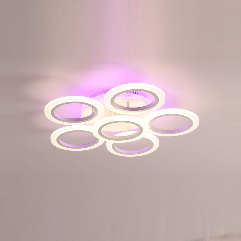 Circular, multi-ring LED ceiling lamp providing soft, ambient lighting for a modern interior space.