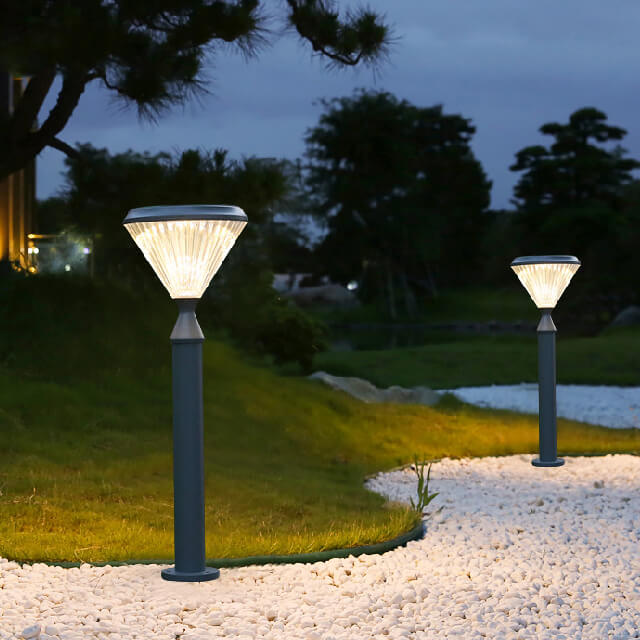 diamond shape unique solar powered bollard light installed on a sandy path