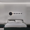 Minimalist modern wall sconce with circular and semicircular elements